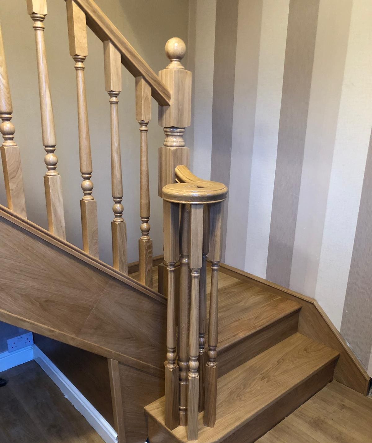 A traditional turned oak staircase renovation with stylish volute in Buckley.