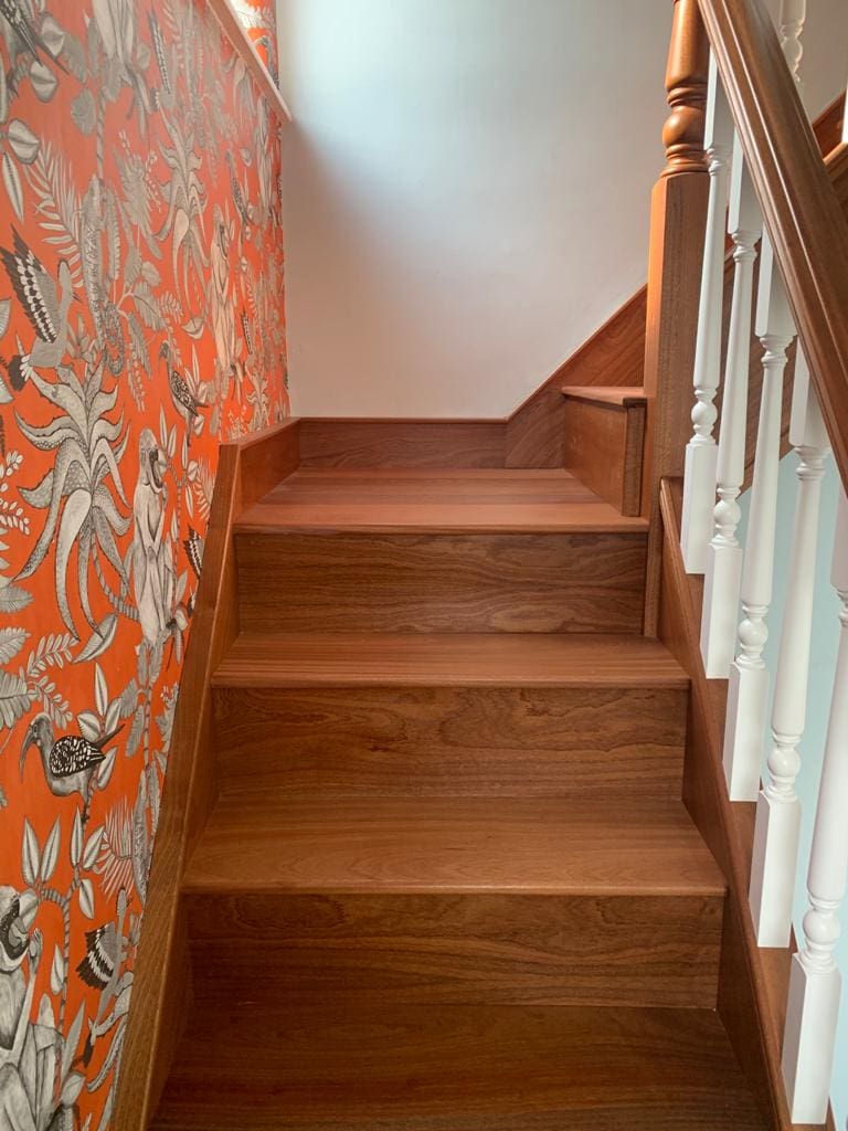 An elegant combination of natural sapele & contrasting white turned spindles in Woolston complete with an elegant volute.